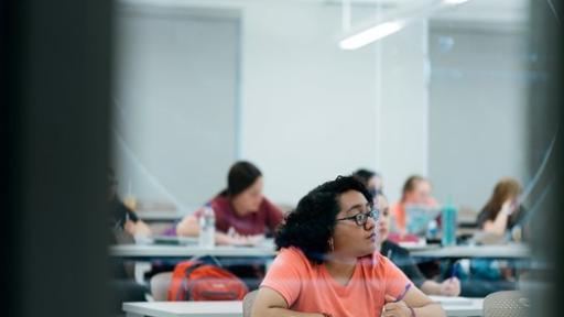 students taking  notes during a lecture